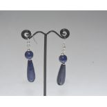 A pair of large lapis lazuli drop earrings, each with torpedo drop beneath a bead, on fish hook