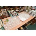 Two trays containing a large group of 19th century and later cut-glass drinking glasses inc.