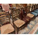 A set of four 19th century rush seated Lancashire ladder back chairs