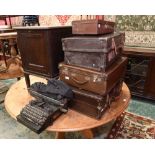 Four vintage leather suitcases; tog. with a vintage typewriter