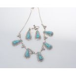 A pair of Mexican silver earrings set with turquoise tog. with a pendant en suite