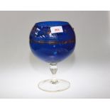 A 19th century large glass brandy balloon, with blue body and gilt highlighting applied with red