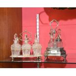 A silver plated cruet stand with central carry handle and with four glass bottles together with a