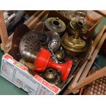 A box of oil lamps, brass and copper