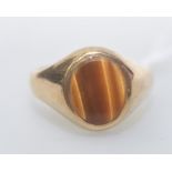 A 9ct gold signet ring set with tigers eye, 5.7 grams