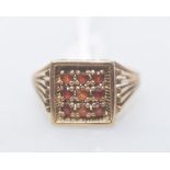 A 9ct gold signet ring set with garnets. 4 grams