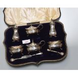 A George VI cased silver six piece condiment set comprising: pairs of pepperettes; mustards and