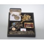 A miscellaneous collection of jewellery, a 'Lucky' dollar and other items