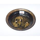 An Oriental papier mache bowl, decorated to the interior with figures and a musician. Diameter 21.