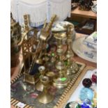 A tray of brass candlesticks, companion set etc