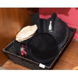 A Police Officer's helmet, a mortar board and three vintage hats
