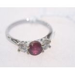 A ruby and diamond three stone ring on an 18ct white gold band. Ruby 0.95ct. Ring size N