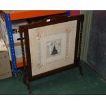 A 19th century silk and lace handkerchief mounted as a firescreen in an oak turned frame