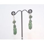A pair of carved jade drop earrings, decorated with flowers