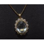 An aquamarine and diamond cluster pendant on an 18ct gold chain. Aquamarine 4.71ct. Diamond 1.18ct