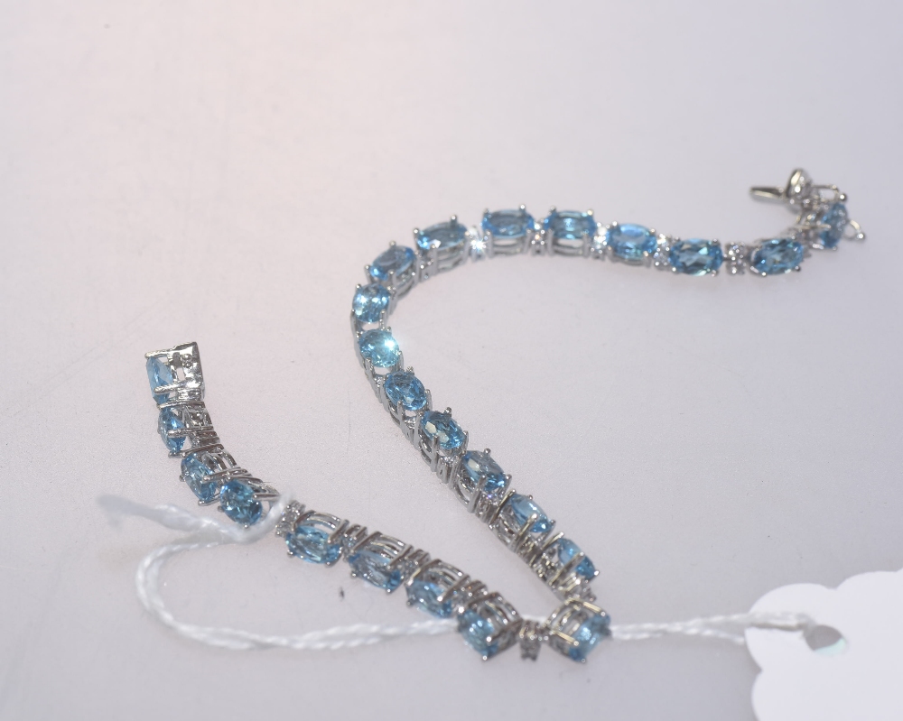 A blue topaz and diamond bracelet mounted in 18ct white gold. Blue topaz 12.73ct. Diamonds 1.25ct.