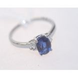 A sapphire and diamond ring with diamond baguette shoulders on a 18ct white gold band. Sapphire 1.