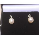 A pair of diamond and fresh water pearl drop earrings mounted in 9ct gold