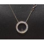 A diamond circle pendant on an 18ct white gold chain. 0.50ct