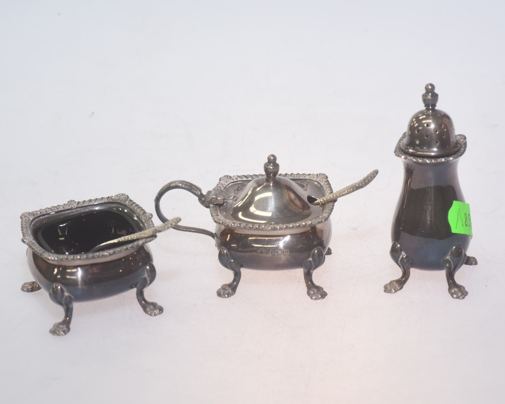 A silver cruet set comprising a square shaped mustard pot & salt cellar with blue glass liners and a