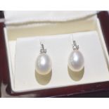 A pair of diamond and fresh water pearl drop earrings mounted in 9ct gold
