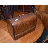 An oak cased Singer sewing machine