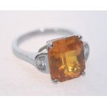 A yellow sapphire and diamond half moon ring mounted in 18ct white gold. Sapphire 7.32ct. Diamonds