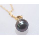 A Tahitian black pearl pendant on an 18ct gold chain.