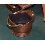 A copper and brass helmet form coal scuttle