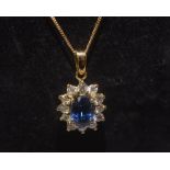 A sapphire and diamond cluster pendant on an 18ct gold chain. Sapphire 1.61ct and diamonds 0.49ct