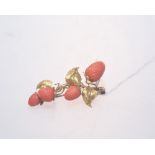 A gold and coral strawberry form bar brooch, unmarked but tests as gold.