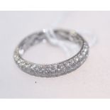 A diamond half hoop eternity ring on an 18ct white gold band. 0.85ct. Ring size O