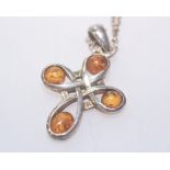 A silver and amber cross pendant on chain, stamped 925