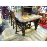 A 19th Century lunette carved oak wind-out dining table raised on cup and cover legs tog. with