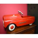 A vintage painted Triang pedal car