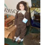 A vintage shop display doll on stand in period style clothing