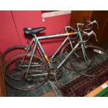 Two vintage road bikes, a Peugot and a Viking