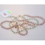 A graduated pearl necklace and a pink pearl necklace with 9ct gold clasps (2)