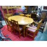 A pine dining table tog. with a set of six matching chairs inc. two carvers