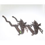 A pair of bronzed metal figures of dragons