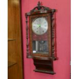 A 19th century cross banded mahogany Vienna wall clock with turned uprights and further tunbridge