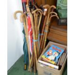 A large quantity of walking sticks, umbrellas, golf clubs etc