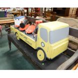 A vintage toy ride on painted wooden truck