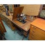 An oak and cast iron treddle Singer sewing machine