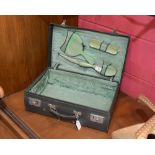 A 1930s ladies dressing case fitted with a set of bakelite backed  brushes and comb