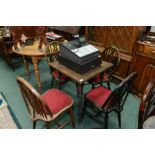 An oak table and four windsor style wheelback chairs
