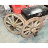 A pair of vintage iron bound cart wheels