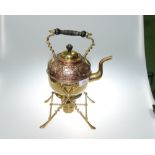 A 19th century brass and copper tea kettle and stand