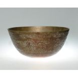 A Chinese patinated metal temple bowl engraved with dragons, phoenix and lotus blossoms, and cast to