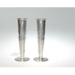 A pair of Solkets for Liberty & Co tudric pewter vases impressed with stylised flowers. No. 820.